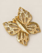 Broche Papillon Ajouré Doré, packshot sur fond beige
