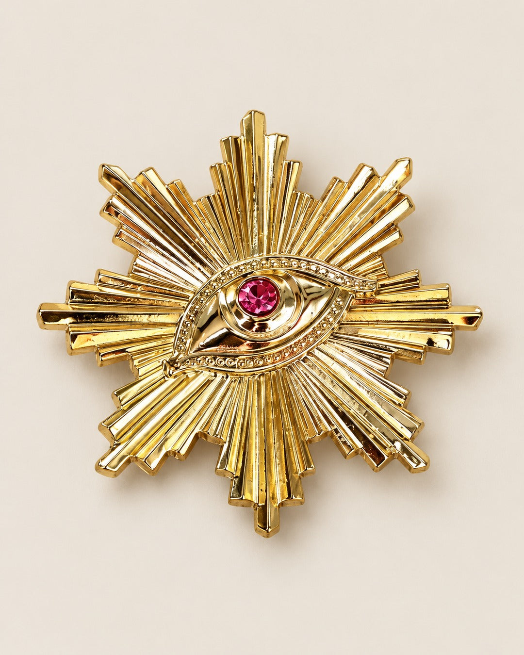 Broche Soleil Œil Strass Doré, packshot sur fond beige